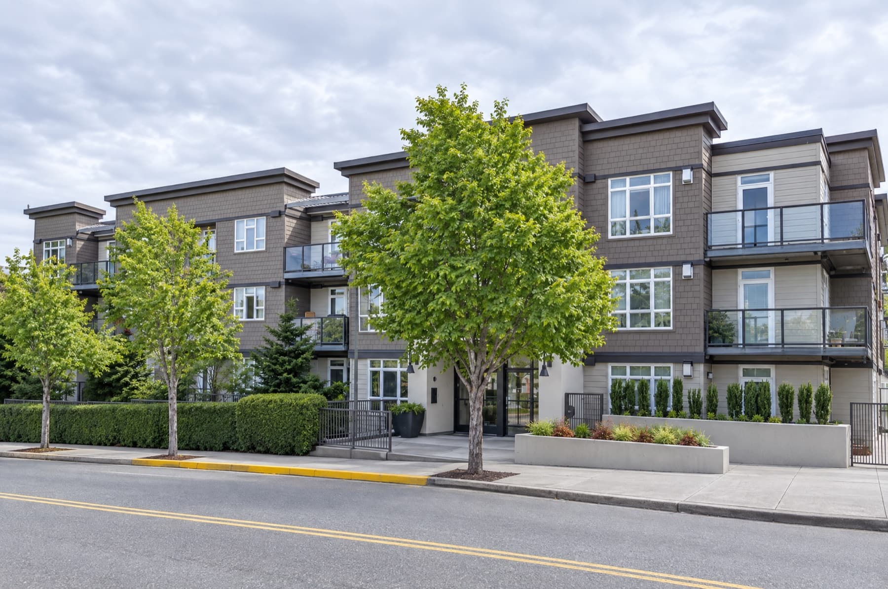 Illustration of 128 on State Apartments in Kirkland, with balconies and a landscaped entrance
